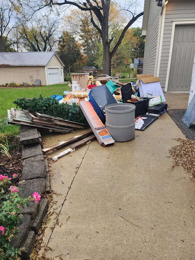 Dumpster being loaded with debris for Roofing Dumpster Rental in Muhlenberg